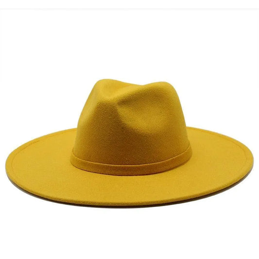Mustard yellow British style fedora hat with wide brim on white background