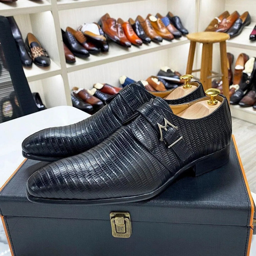 Black textured leather men's dress shoes displayed on a box in a shoe store.