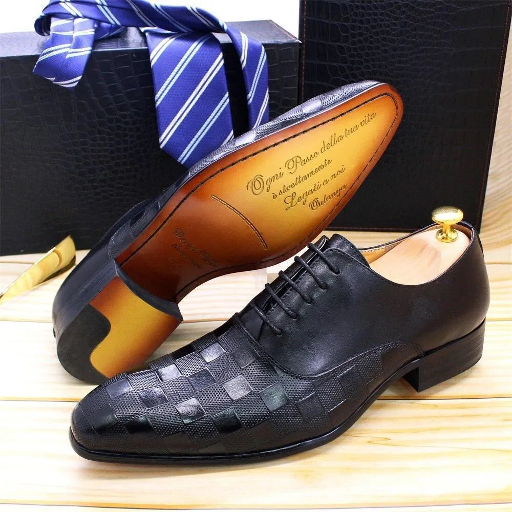 Black checked leather men's dress shoes with wooden shoe tree on wooden surface