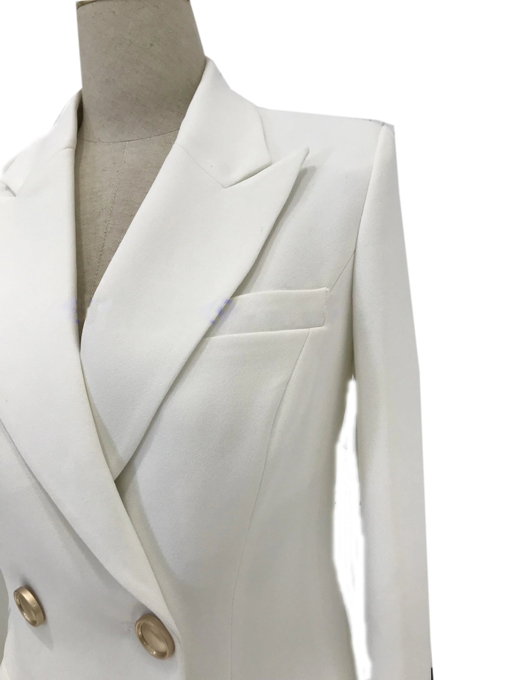 White double-breasted women's pantsuit blazer with gold buttons on mannequin