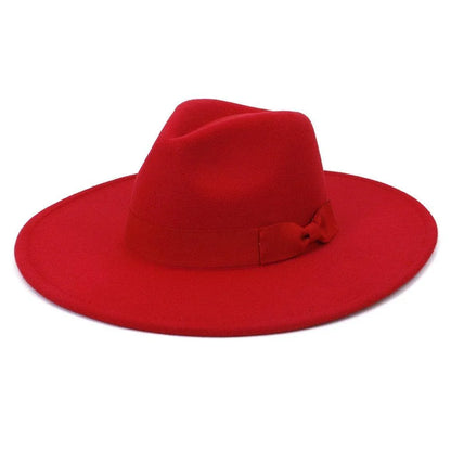 Wide brim red retro fedora hat with ribbon on white background