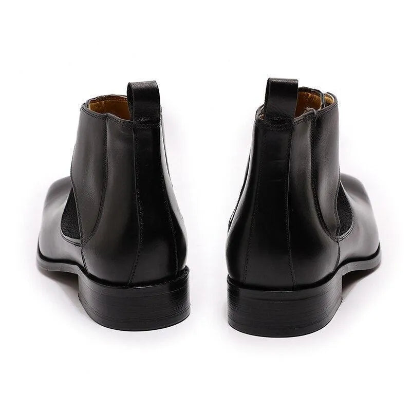 Back view of black leather ankle dress boots on white background
