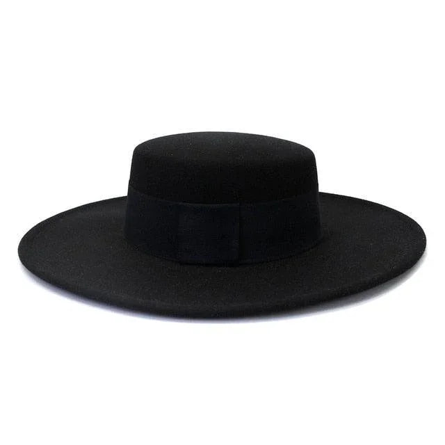 Black derby fedora hat with wide flat brim on white background