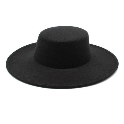 Black derby fedora hat with wide flat brim on white background