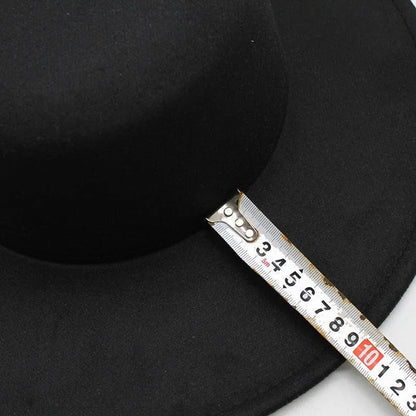 Black derby fedora hat with a tape measure across the brim for size measurement