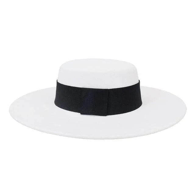 White derby fedora hat with flat wide brim and black ribbon band on white background