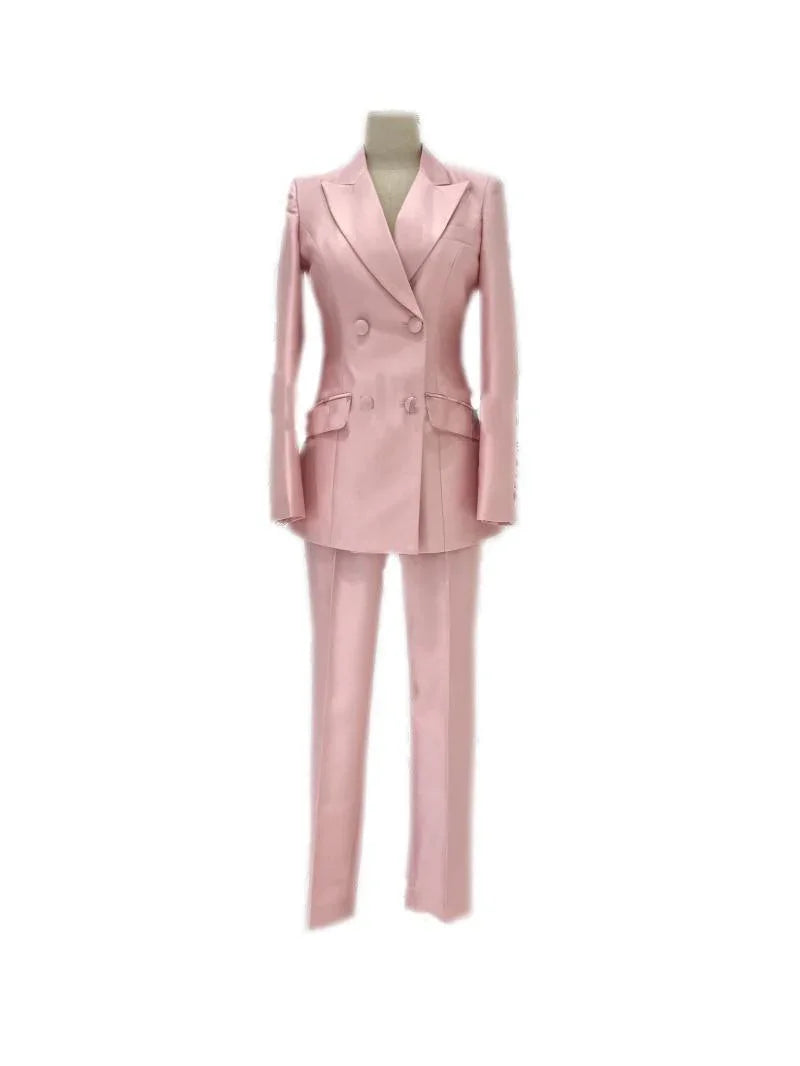 Pink double-breasted women's business pantsuit with blazer and trousers on mannequin