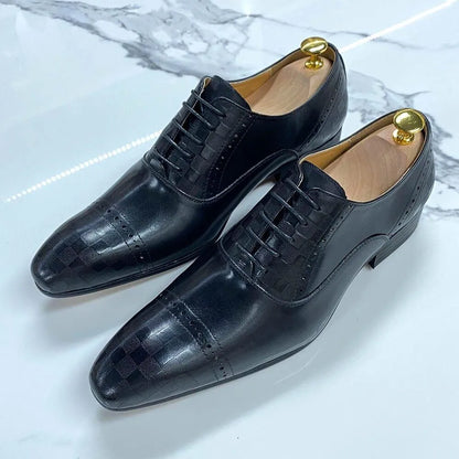 Black leather lace-up men's dress shoes with checker pattern on marble surface