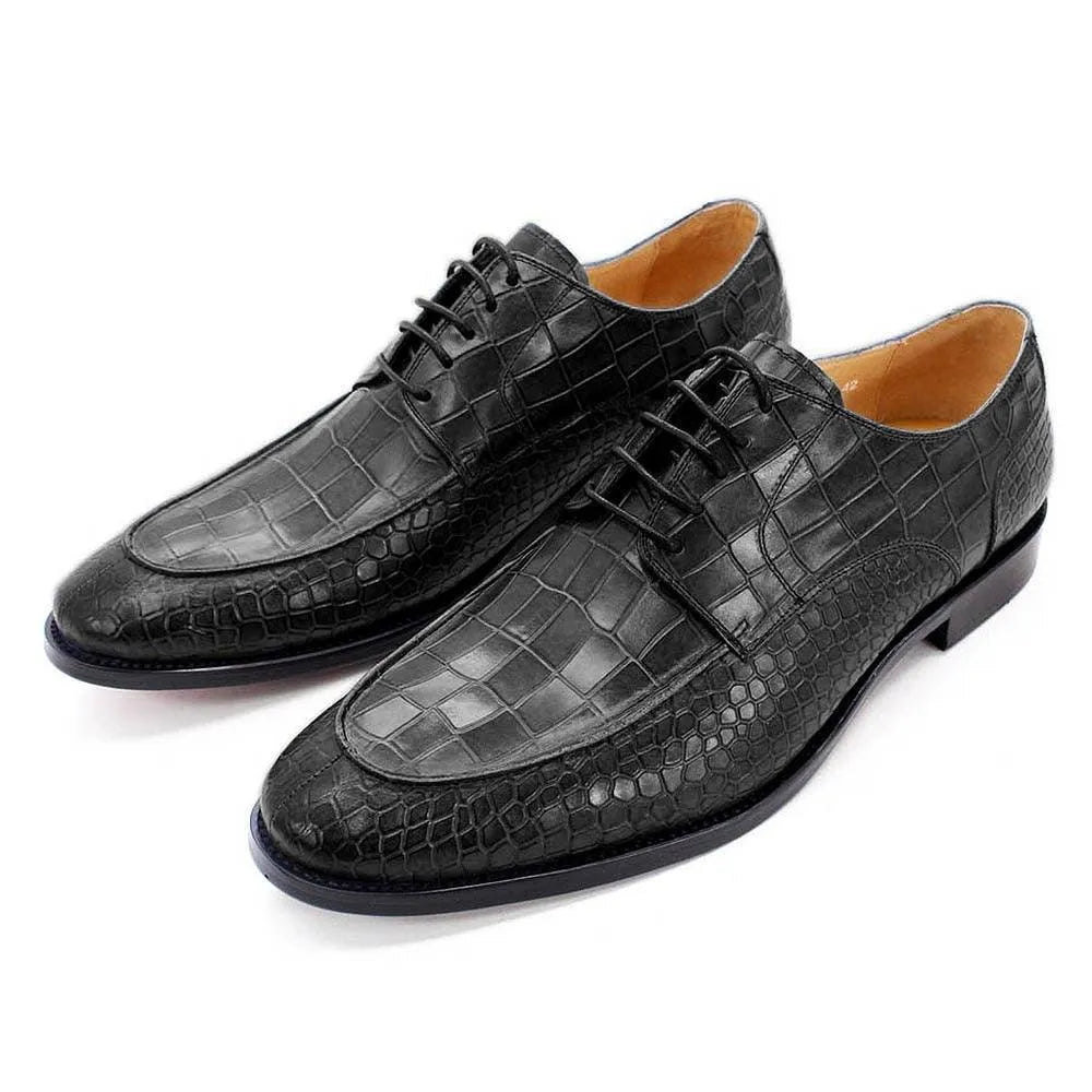 Black crocodile pattern leather men's dress shoes with laces on white background