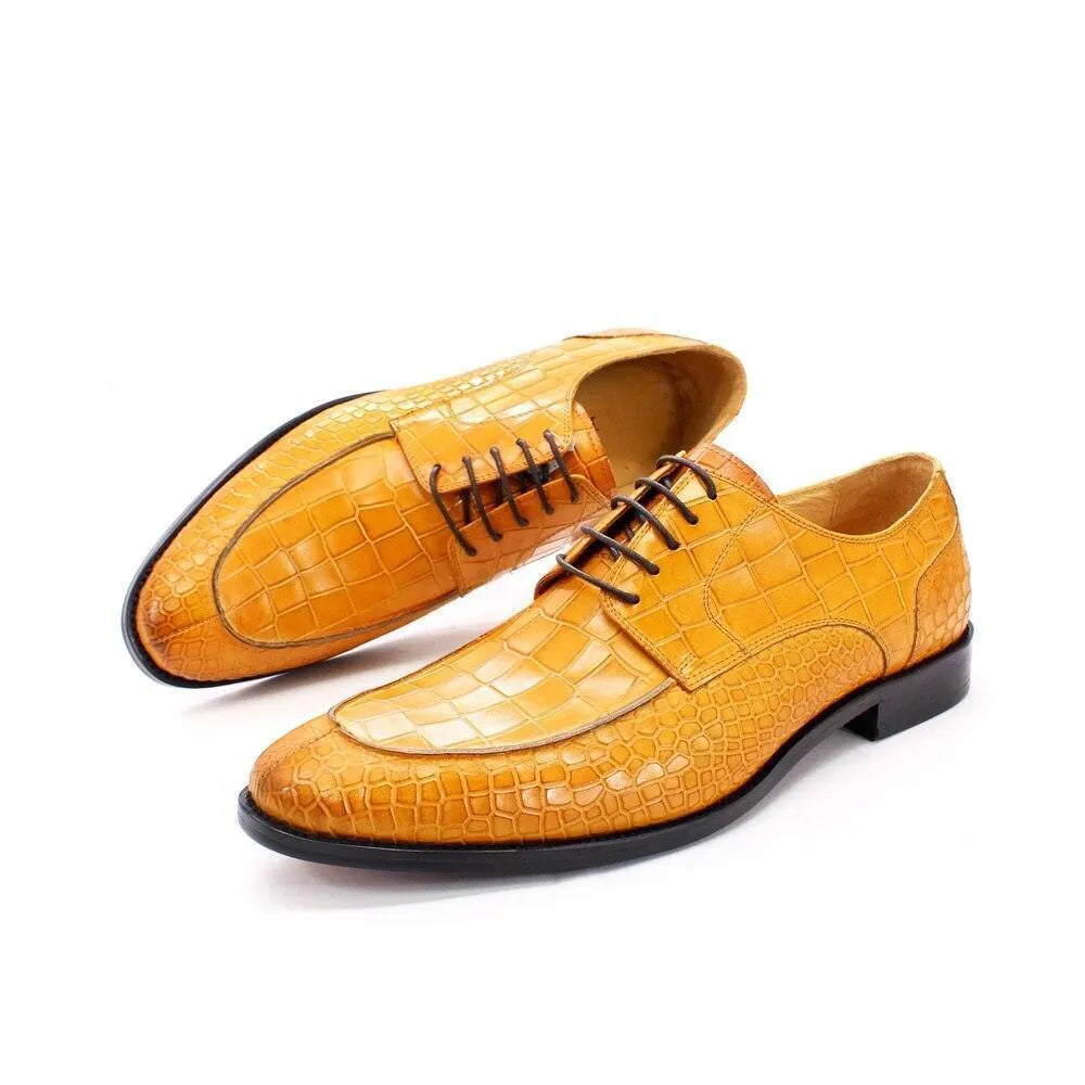 Men’s orange crocodile-pattern leather dress shoes with brown laces on white background