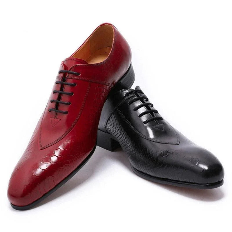 Red and black Levi men's dress shoes with textured leather on white background