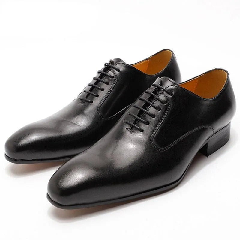 Black leather men's dress shoes, lace-up formal oxford style on white background