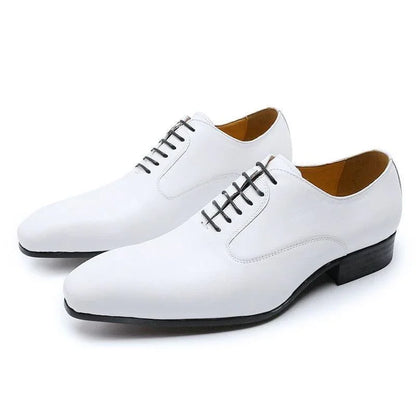 White leather men's lace-up dress shoes with black soles and minimalist design