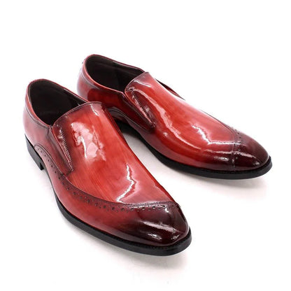 Glossy red slip-on men's dress shoes with black soles and decorative toe detailing