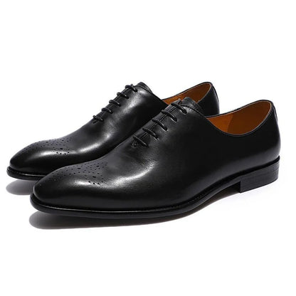 Black leather men's oxford dress shoes with closed lacing on white background