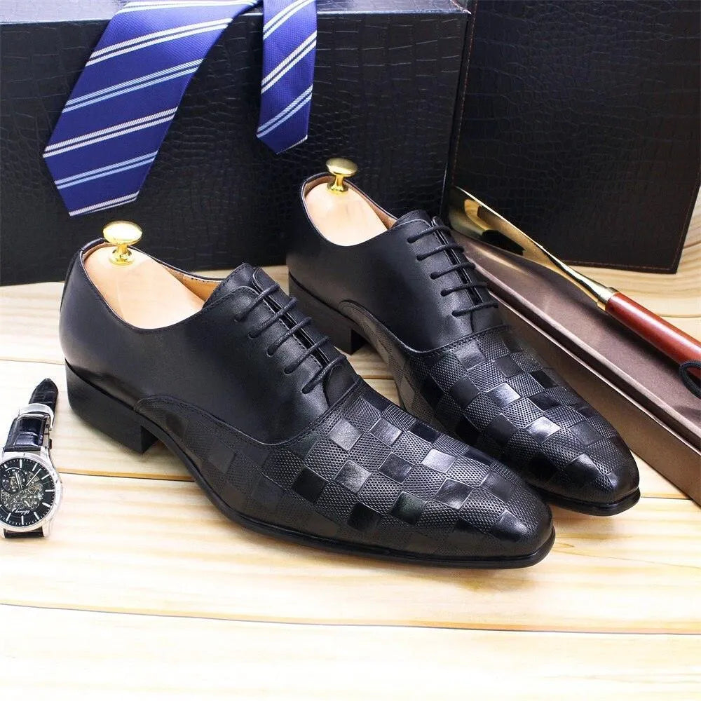Black checked leather men’s dress shoes with laces on wooden surface, blue striped tie