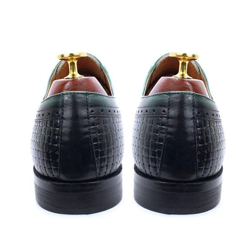 Rear view of black woven leather men's dress shoes with green trim and shoe trees