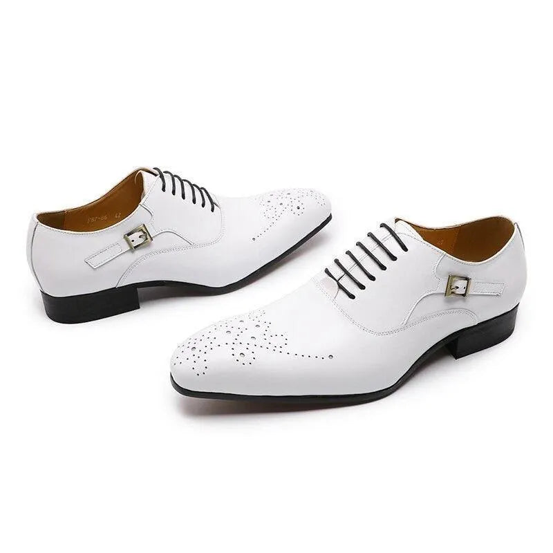White men's lace-up dress shoes with brogue detailing and silver buckles on a white background