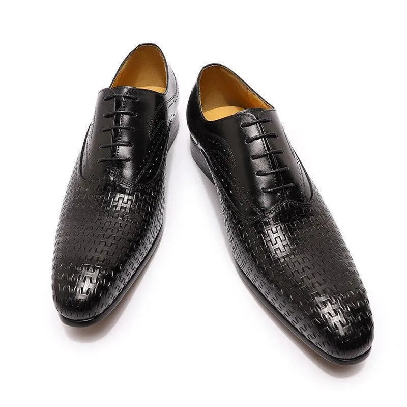 Black leather pointed-toe dress shoes with textured woven pattern on white background