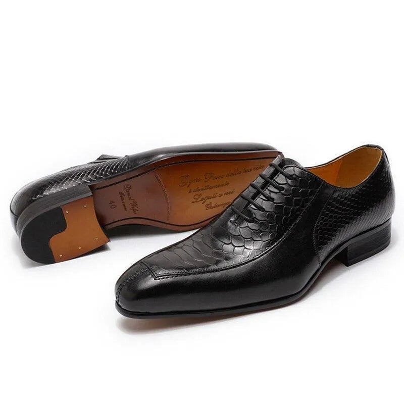 Black leather men's dress shoes with textured pattern on white background