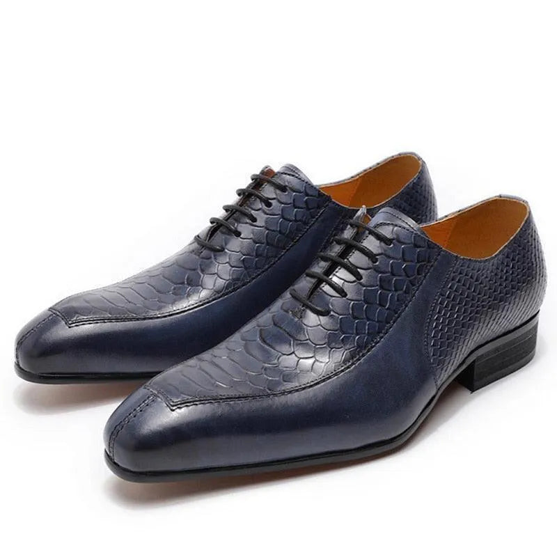Men's navy blue dress shoes with textured, snakeskin-style leather and black laces