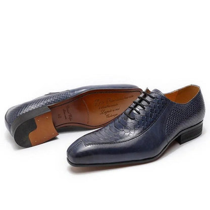 Men's blue leather dress shoes with textured scale pattern on white background