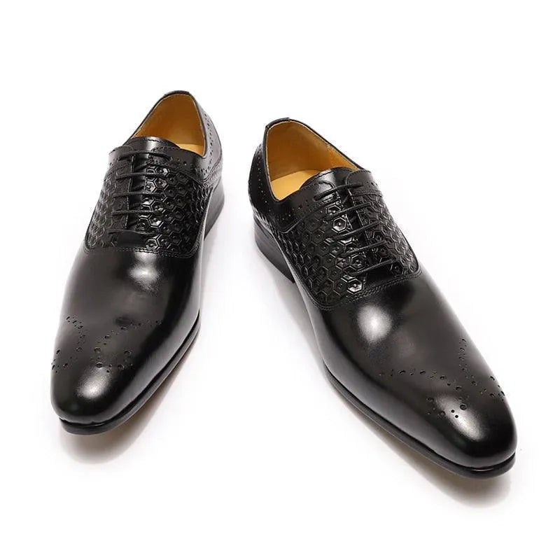Glossy black men's dress shoes with textured uppers and brogue detailing on white background