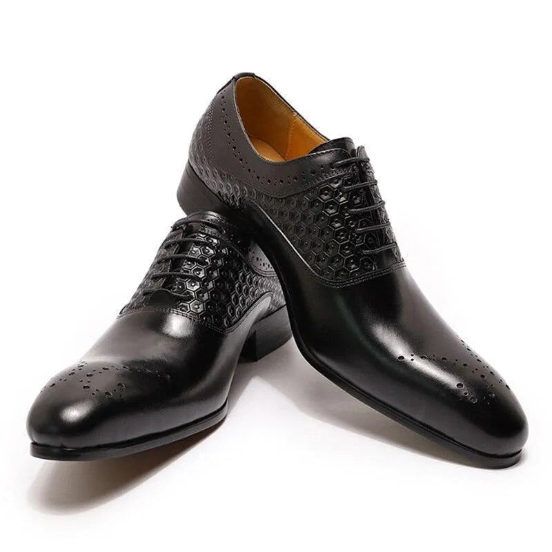Glossy black men's dress shoes with hexagonal pattern and brogue detailing on white background