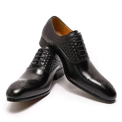 Glossy black men's dress shoes with hexagonal pattern and brogue detailing on white background
