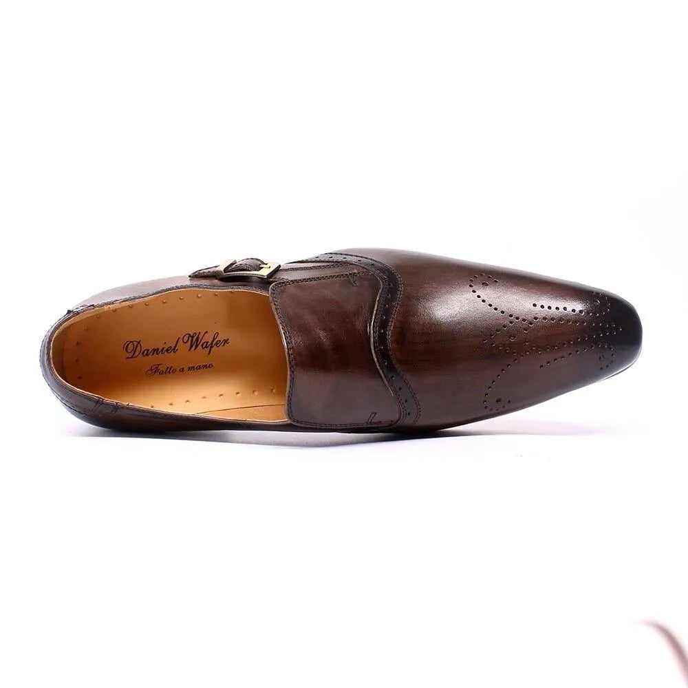 Brown leather men's dress shoe with pointed toe and brogue detailing on white background