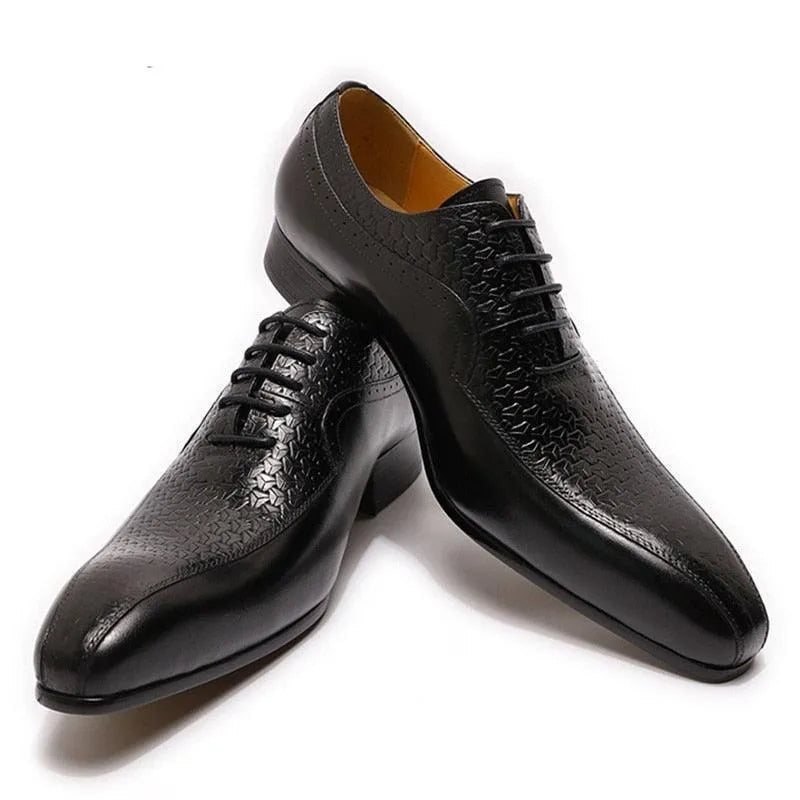 Black pointed toe men's dress shoes with textured leather pattern on a white background