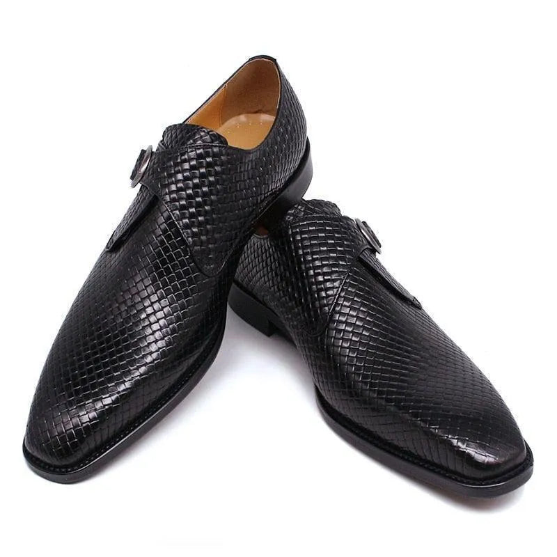 Black textured leather men's dress shoes with buckle detail on white background