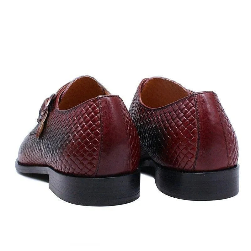 Back view of brown woven leather men's dress shoes with black soles on white background