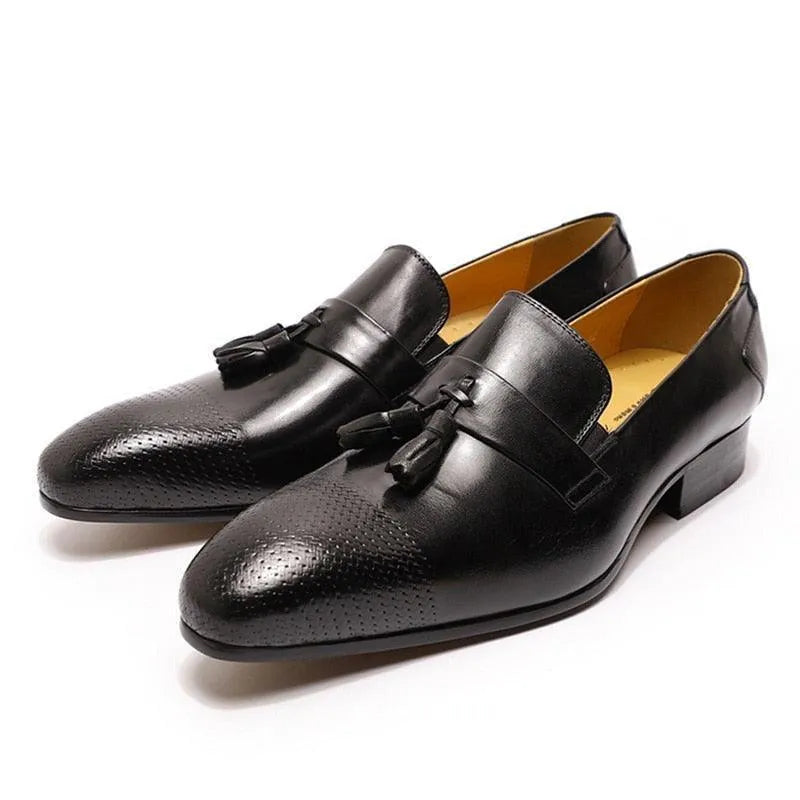 Black leather men's tassel dress shoes with perforated toe detail on white background
