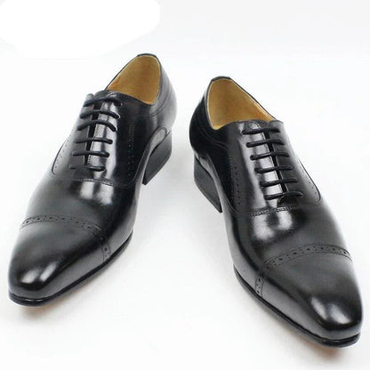 Black leather men's dress shoes with lace-up design on white background