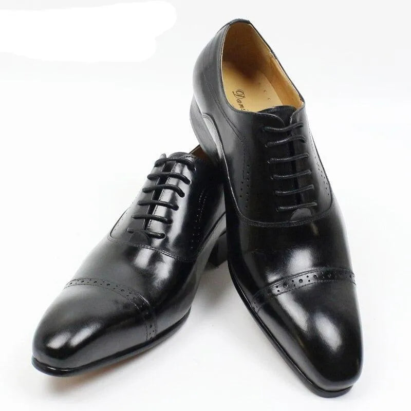 Black leather lace-up men's dress shoes with cap toe on white background