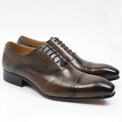 Brown leather men's dress shoes lace-up classic cap toe style on white background