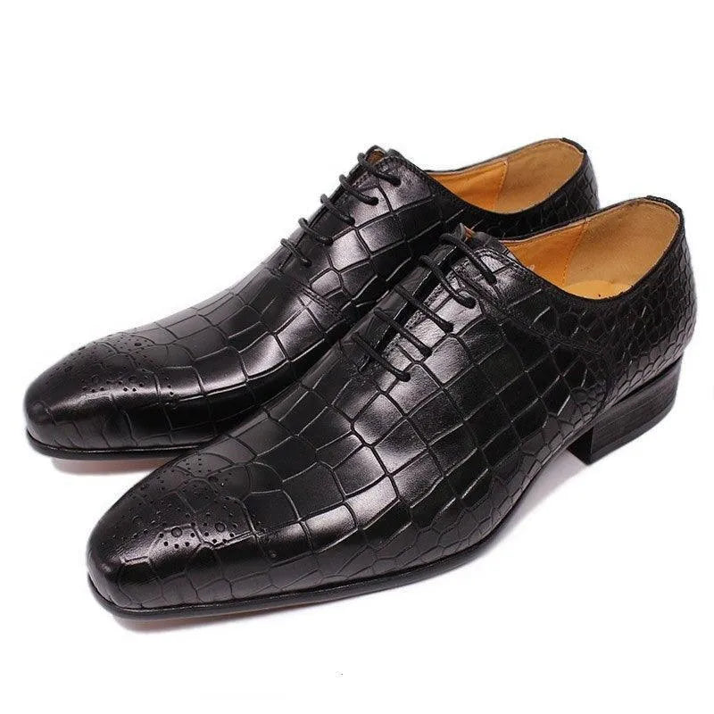 Black crocodile pattern leather dress shoes for men with laces on white background