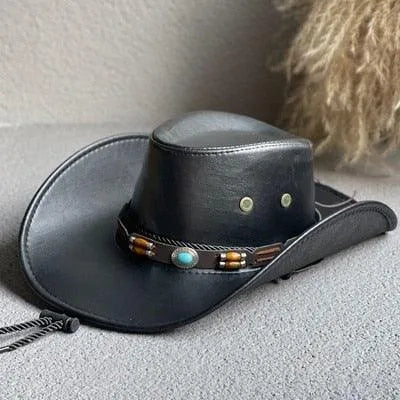 Black faux leather western cowboy hat with turquoise and bead band on gray fabric