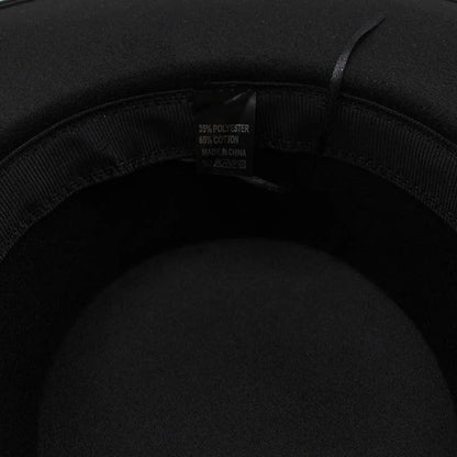 Closeup inside black fedora hat showing fabric label with polyester and cotton blend