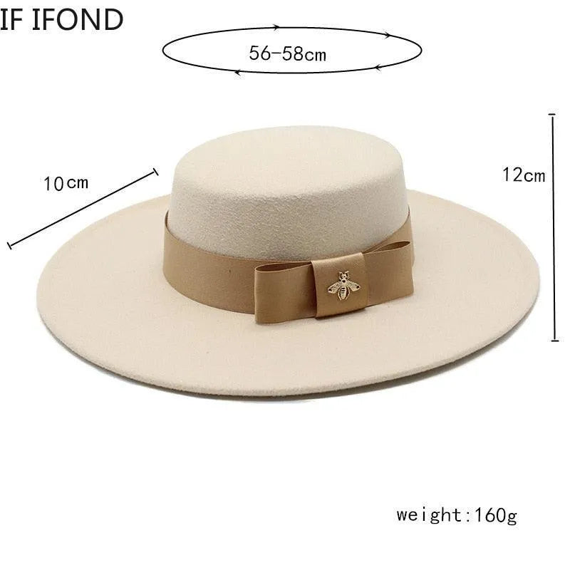 Beige flat top fedora hat for women with tan bowknot and bee brooch, size chart visible.