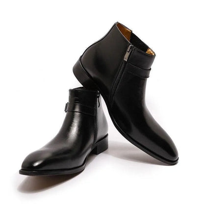 Black leather ankle boots with side zippers on a white background