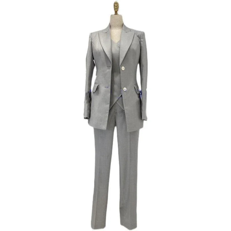 Grey three-piece women's pantsuit with blazer, vest, and trousers on mannequin