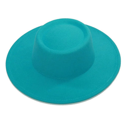 Vibrant turquoise fedora hat with flat wide brim on white background