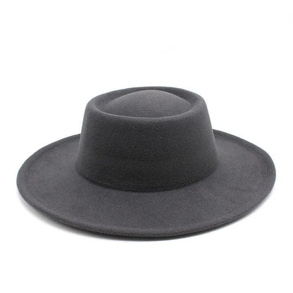 Black fedora hat with wide brim on white background, stylish men's accessory