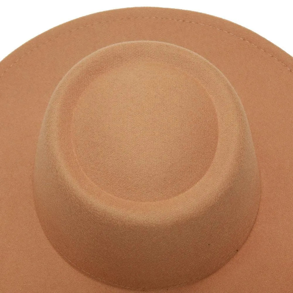 Tan wool fedora hat with wide brim, close-up top view on plain background