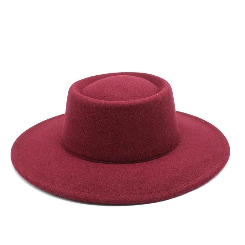 Burgundy fedora hat with wide brim and flat crown on white background