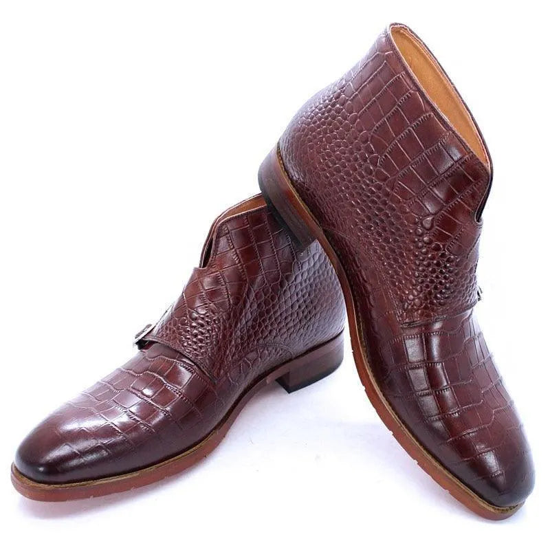 Men's brown crocodile-embossed leather ankle boots with side buckles on white background