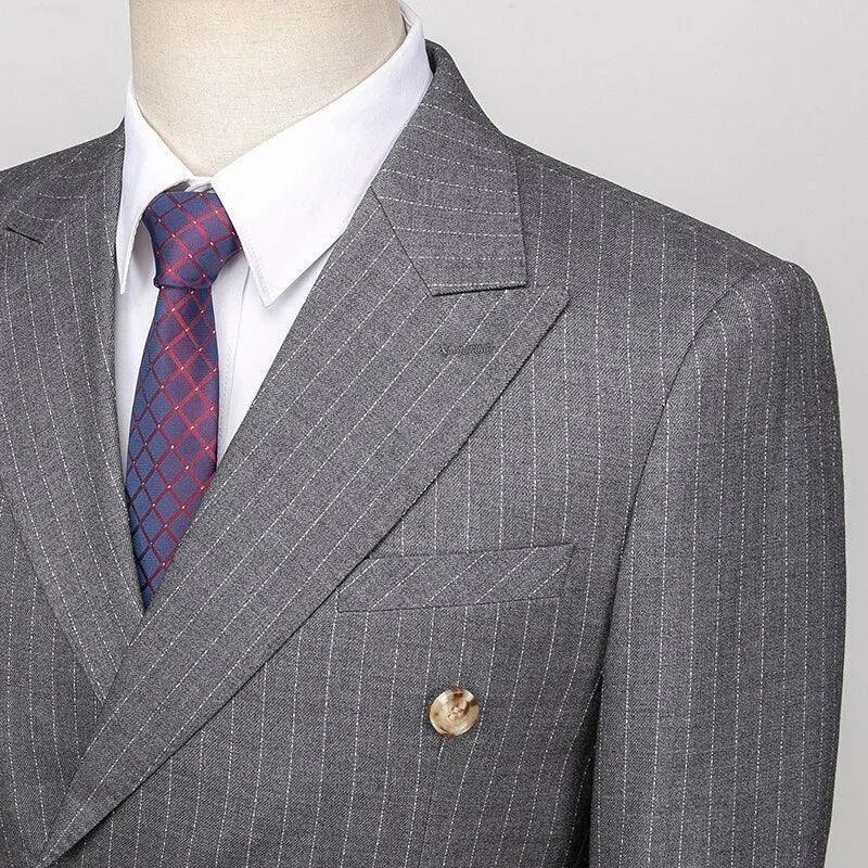 Grey pinstripe double-breasted men's suit with white shirt and patterned tie