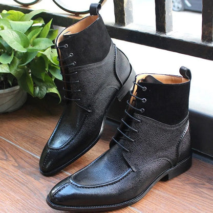 Black leather lace-up ankle boots with textured finish on wooden floor.